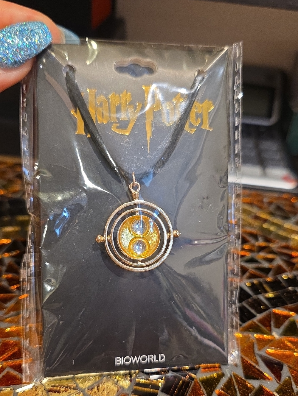 Bioworld Gold-Tone Time-Turner Style Necklace with Blue Accents
